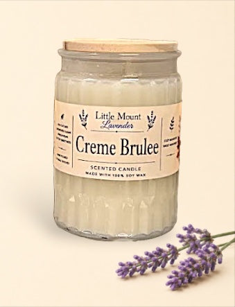 Little Mount Lavender Creme Brulee scented soy wax candle in a textured glass jar with a wooden lid and lavender sprig