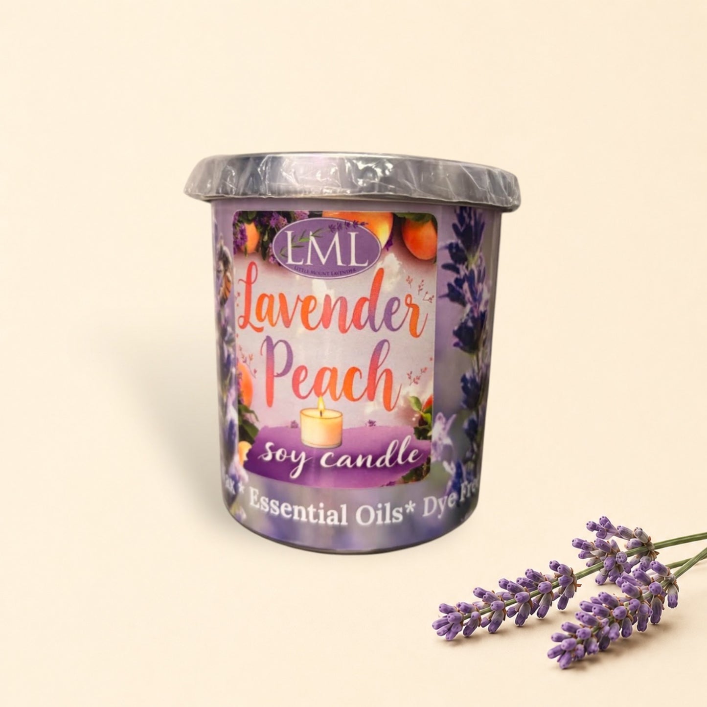 Little Mount Lavender soy candle in a purple glass jar with lavender and peach scent, surrounded by fresh peaches.