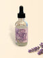 Lavender aromatic body oil in a clear glass dropper bottle with a purple label.