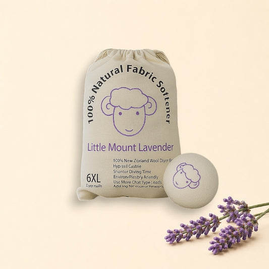 Bag of Little Mount Lavender natural fabric softener with a softener ball on a laundry room floor.