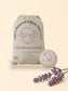 Bag of Little Mount Lavender natural fabric softener with a softener ball on a laundry room floor.