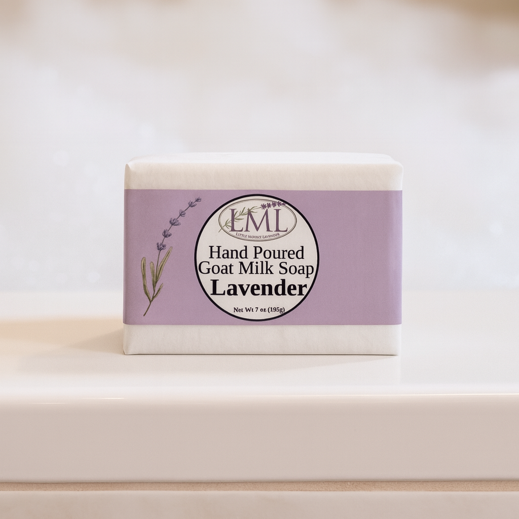 Bar of lavender goat milk soap with a purple label on a white surface