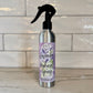 Silver spray bottle with lavender hydrosel label on a tiled wall background