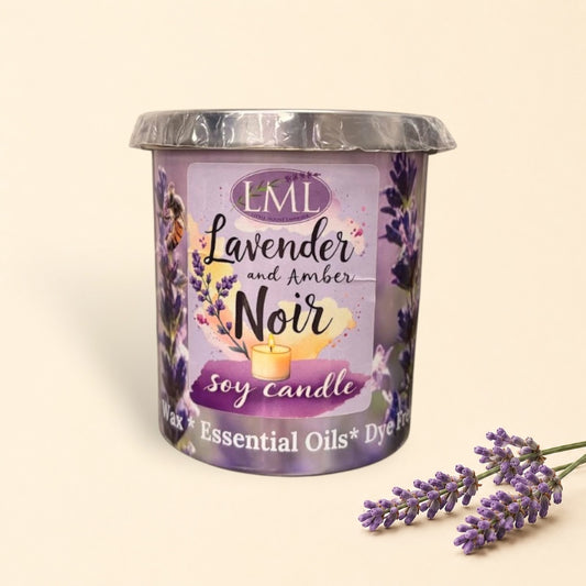 Little Mount Lavender soy candle in a decorative glass jar with amber stones on a dark wooden surface.