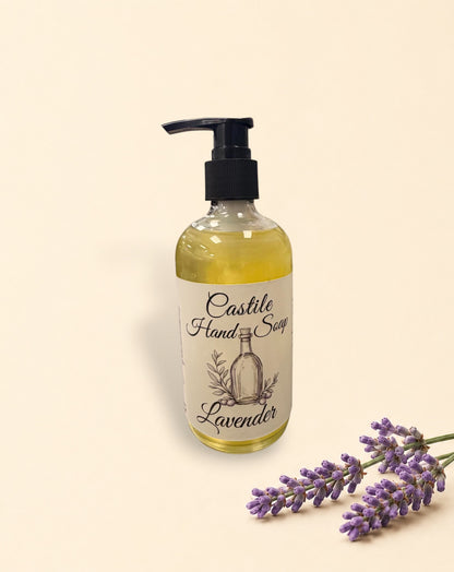 Two Little Mount Lavender castile hand soap bottles with pump dispensers and fresh lavender sprigs on beige background