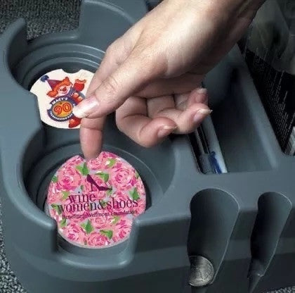 Little Mount Lavender ceramic car coasters with floral and event designs, featuring cork backing in a cup holder.