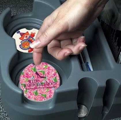 Little Mount Lavender ceramic car coasters with floral and event designs, featuring cork backing in a cup holder.