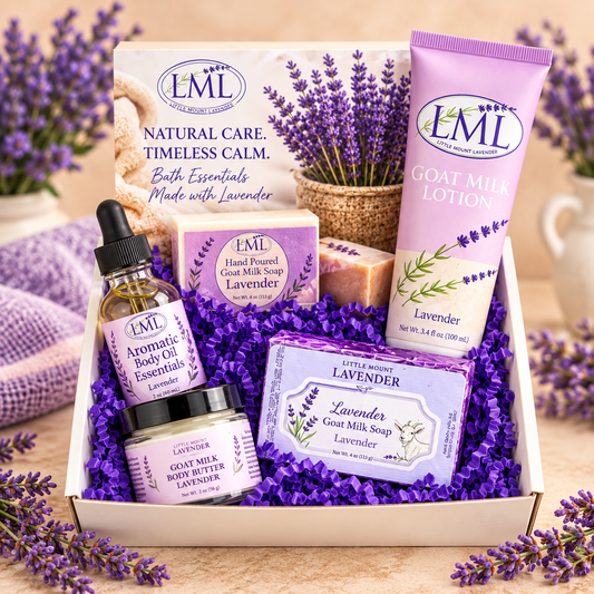 Deluxe Lavender Skincare Sampler Box with goat milk lotion, body oil, goat milk soaps and body butter on warm cream background
