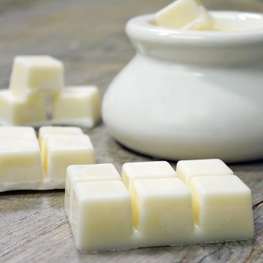 Little Mount Lavender driftwood and lavender soy wax melt cubes on a rustic wooden surface with a white ceramic bowl.