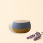 Little Mount Lavender Drum Mist ultrasonic diffuser with blue fabric and wood finish, emitting cool mist while reading