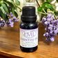Little Mount Lavender essential oil blend of lavender and honeysuckle in a dark glass bottle with purple flowers.