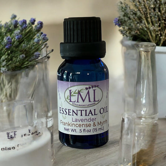 Little Mount Lavender essential oil blend of lavender, frankincense, and myrrh in a blue glass bottle with black cap.