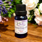 Little Mount Lavender essential oil blend of lavender and rose in a blue glass bottle on a wooden surface.