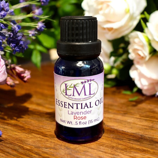 Little Mount Lavender essential oil blend of lavender and rose in a blue glass bottle on a wooden surface.