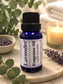 Little Mount Lavender fragrance oil in a cobalt blue glass bottle with lavender sprigs on a beige background.