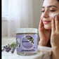 Little Mount Lavender goat milk facial cleanser cream with lavender, applied to a woman's cheek for skincare.