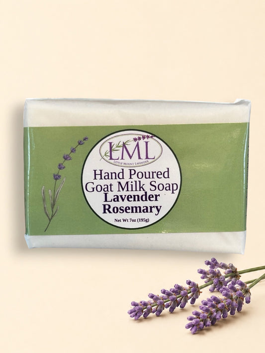 Little Mount Lavender handcrafted goat milk soap bar with lavender and rosemary scent, set against a garden background.