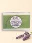 Little Mount Lavender handcrafted goat milk soap bar with lavender and rosemary scent, set against a garden background.