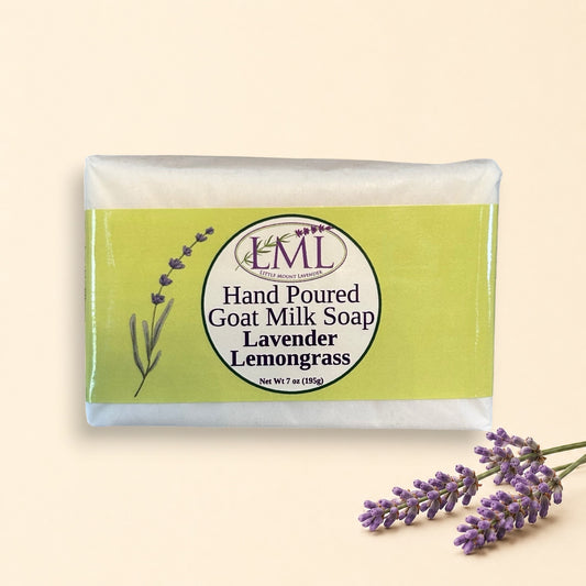 Little Mount Lavender handcrafted goat milk soap bar with lemongrass and lavender scent on a rustic wooden surface.