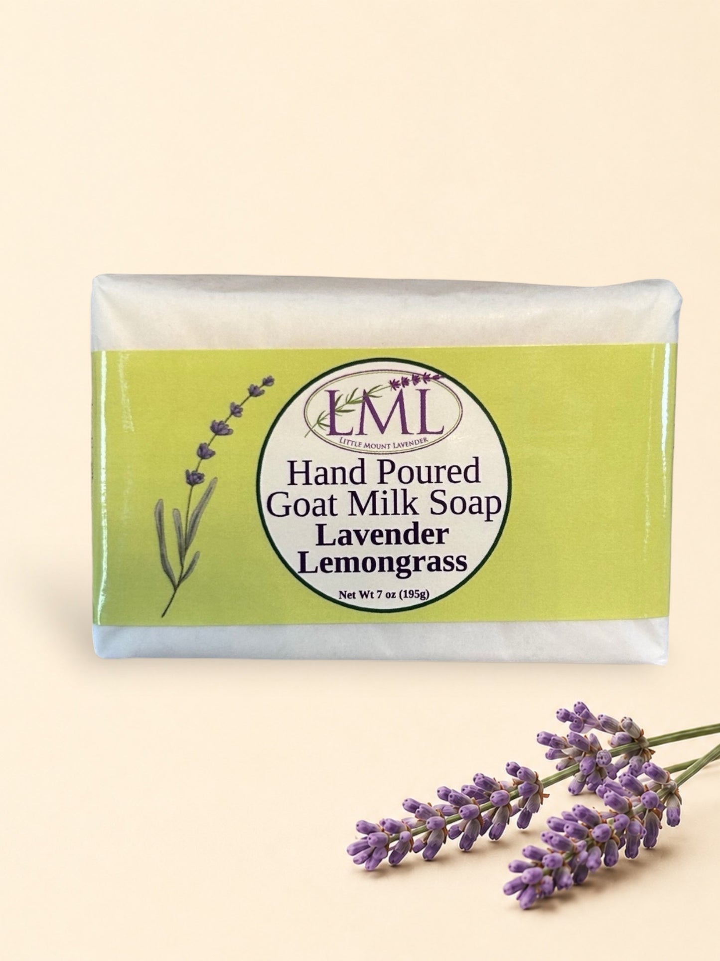 Little Mount Lavender handcrafted goat milk soap bar with lemongrass and lavender scent on a rustic wooden surface.
