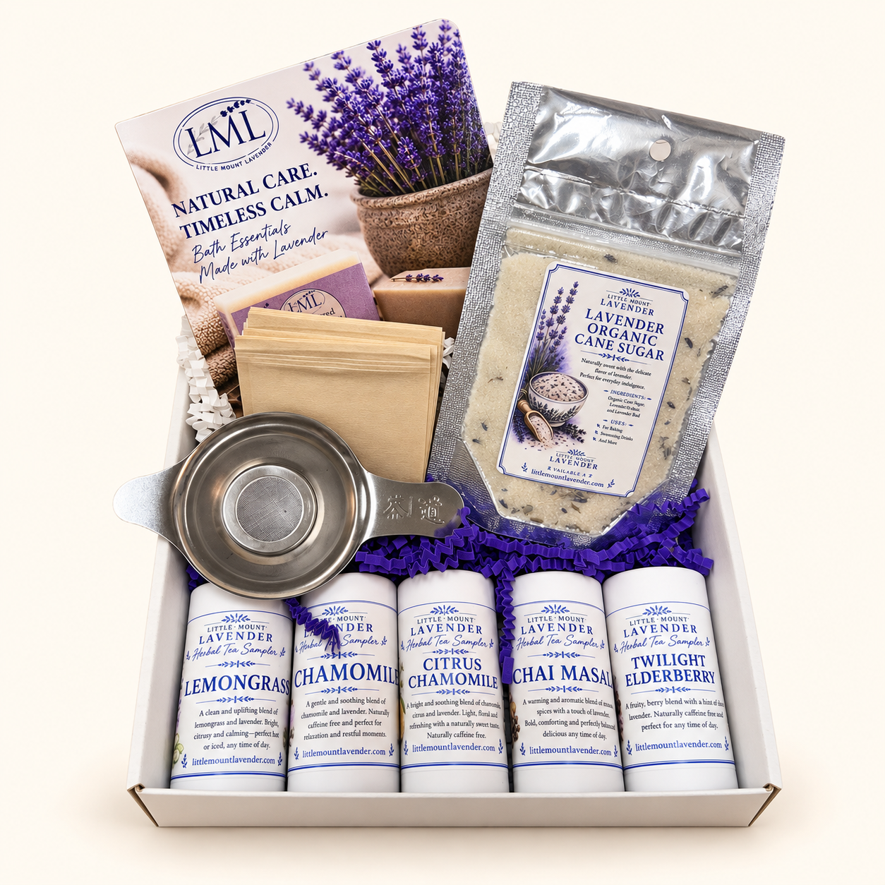 Open herbal tea starter box with five tea samples, infuser, paper tea bags and lavender sugar.