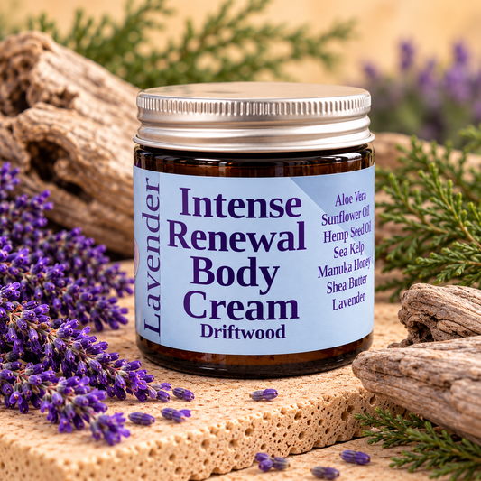 Intense Renewal Body Cream Driftwood with light-blue label, amber jar and silver cap, surrounded by lavender and driftwood on a warm cream background
