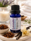 Little Mount Lavender Kentuckian fragrance oil in a cobalt blue glass bottle with a sprig of fresh lavender flowers.