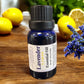 Little Mount Lavender Lemon essential oil in a blue glass bottle on a wooden table with fresh lemons and lavender