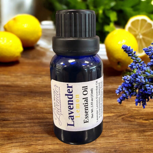 Little Mount Lavender Lemon essential oil in a blue glass bottle on a wooden table with fresh lemons and lavender