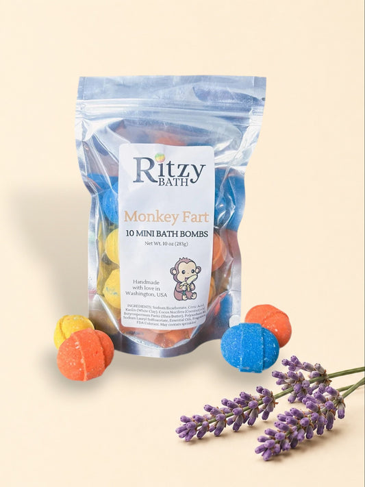 Little Mount Lavender Ritzy Bath Monkey Fart mini bath bombs in a clear pouch with colorful orange, blue, and yellow fizzies.