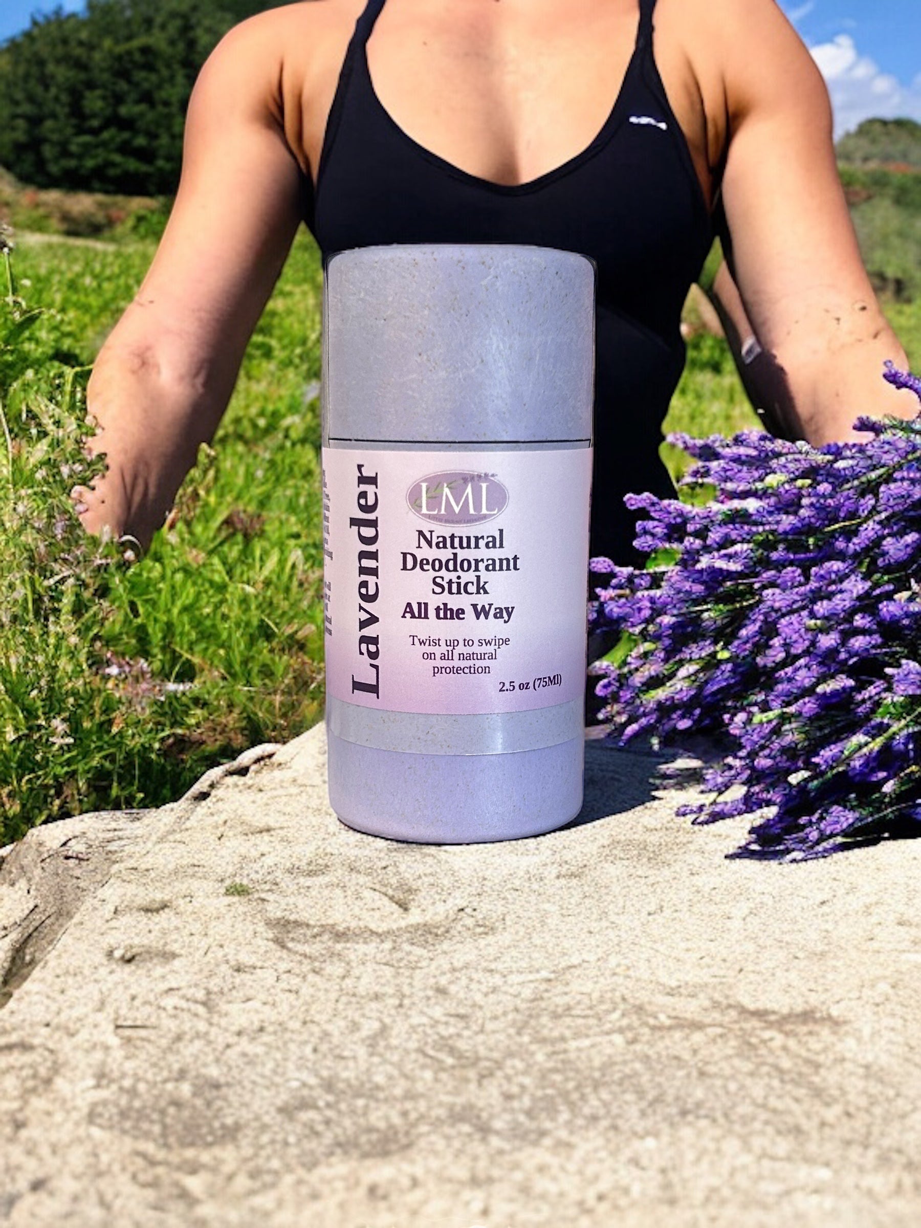 Little Mount Lavender natural deodorant stick in a biodegradable wheat straw container next to fresh lavender flowers.