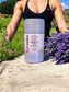 Little Mount Lavender natural deodorant stick in a biodegradable wheat straw container next to fresh lavender flowers.