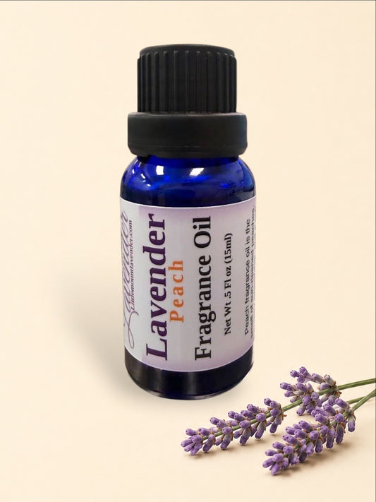 Little Mount Lavender Peach fragrance oil in a 15ml cobalt blue glass bottle with a black cap on a metal surface.
