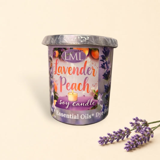 Little Mount Lavender soy candle in a purple glass jar with lavender and peach scent, surrounded by fresh peaches.