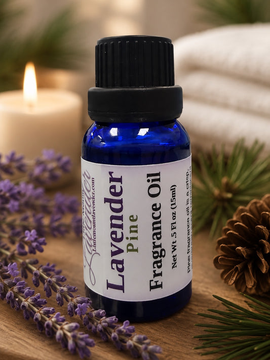 Little Mount Lavender Pine fragrance oil in a cobalt blue glass bottle with a sprig of fresh lavender on a beige background.