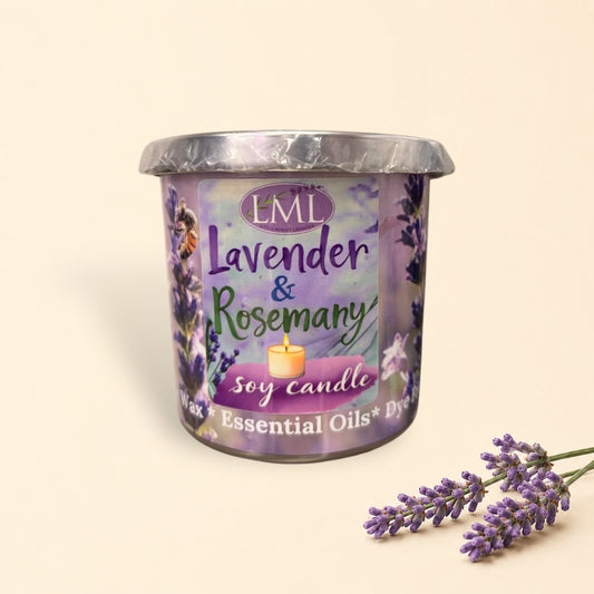 Little Mount Lavender soy candle in a purple glass jar with rosemary and lavender sprigs on a rustic wooden table.