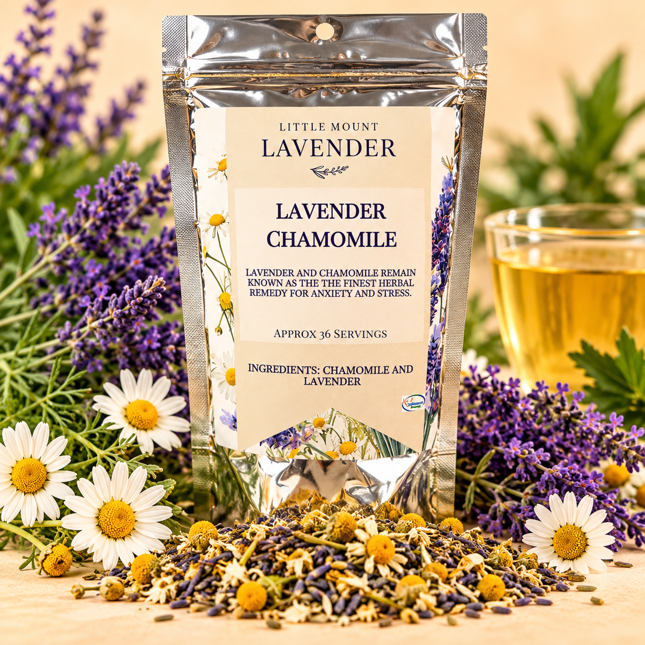 Little Mount Lavender Lavender Chamomile Loose Leaf Tea silver pouch with lavender, chamomile blossoms, loose tea, and golden cup on warm cream background
