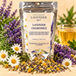 Little Mount Lavender Lavender Chamomile Loose Leaf Tea silver pouch with lavender, chamomile blossoms, loose tea, and golden cup on warm cream background