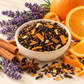 Illustrative styled scene of Orange Spice loose leaf black tea with orange, cinnamon and lavender; not product packaging